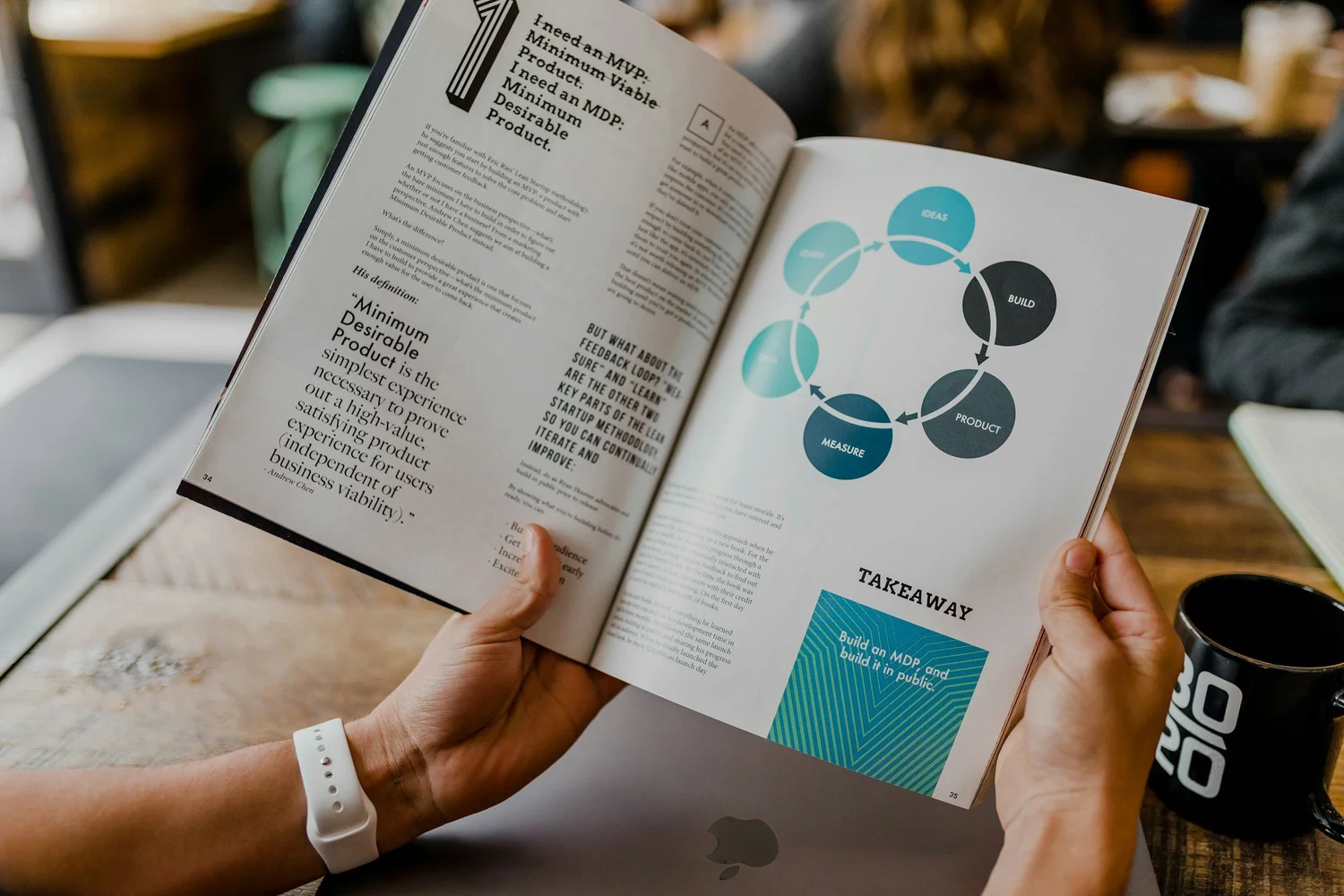 Hands holding a printed annual report booklet